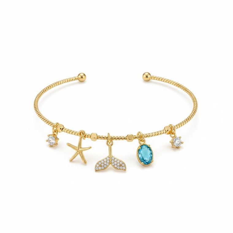 Océan Charm Bangle — gold plated open bangle with starfish and mermaid tail charms